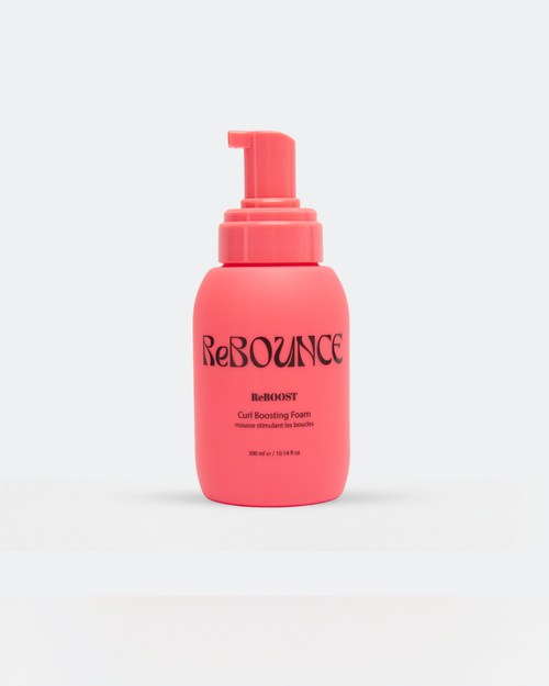 Pink bottle of ReBOUNCE curl boosting foam product - ReBOOST on a white background
