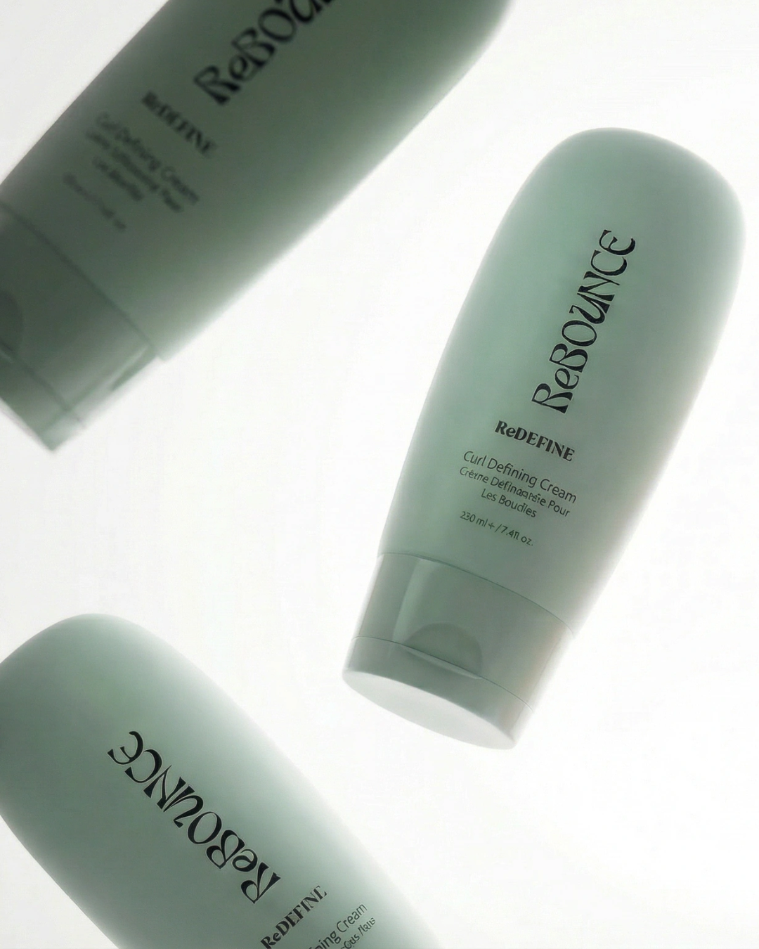 Three bottles of Rebounce Define Curl Defining Cream on a white background