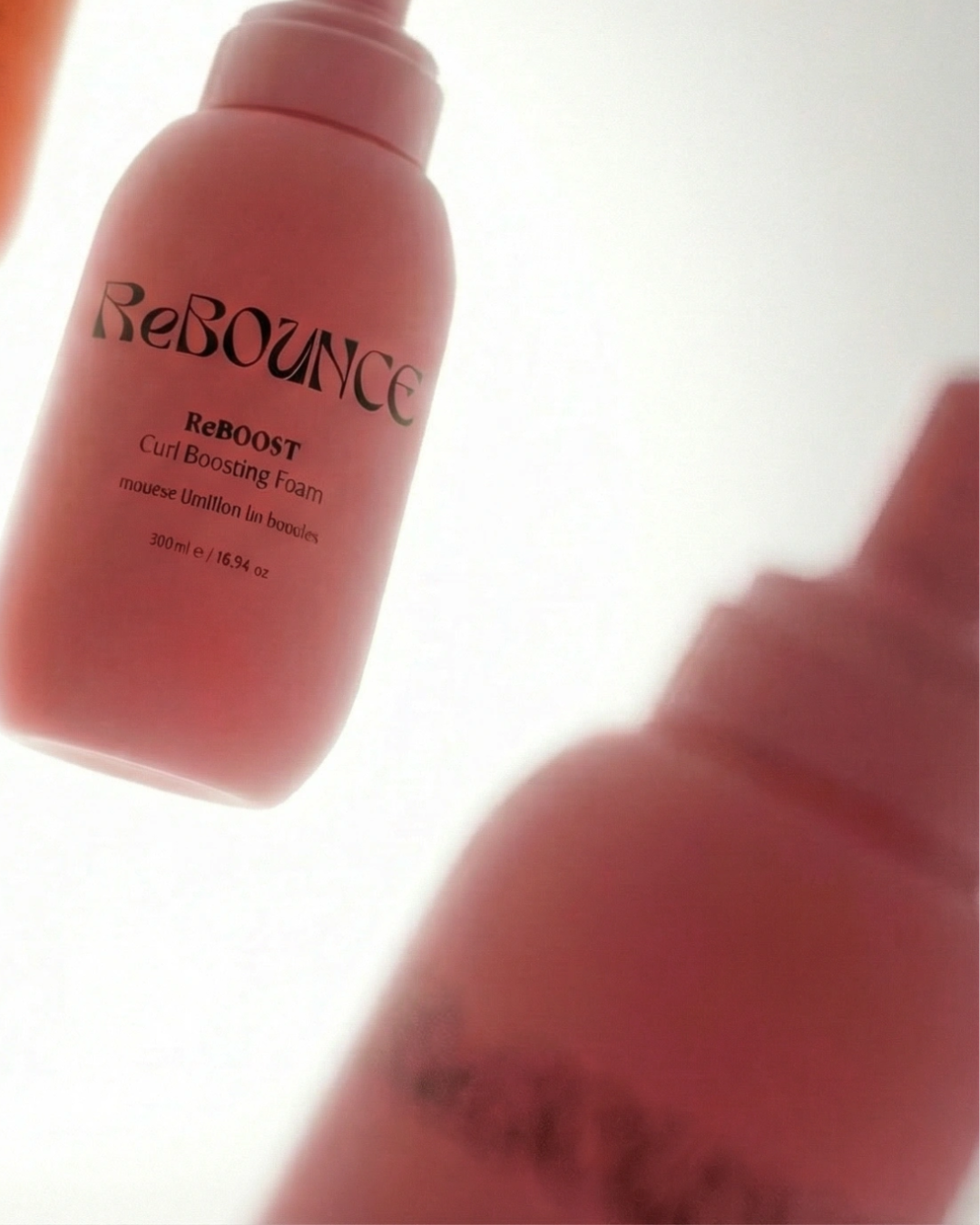 ReBounce hair product bottle with a blurred background