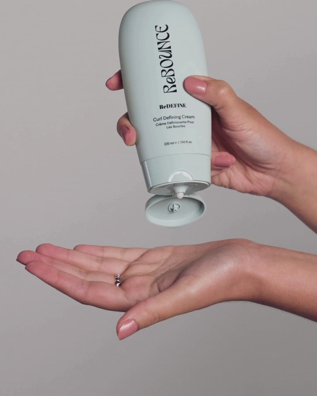 Curly hair woman using ReDEFINE Curl Defining Cream for curly hair